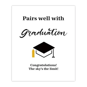 Detail of graduation stickers for wine bottles featuring a black and gold mortarboard icon
