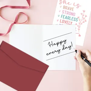 Close-up of greeting card with Happy every day text and dark red envelope set