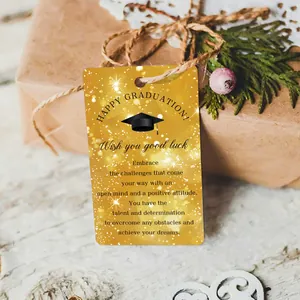 Gold graduation gift tag with black cap and inspirational message on a kraft box
