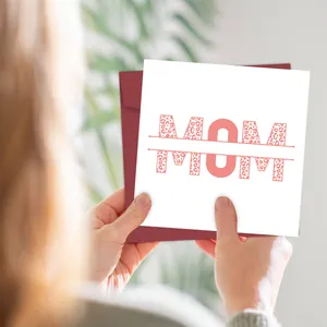Detailed view of a square Mother's Day card with pink leopard print MOM lettering and envelope