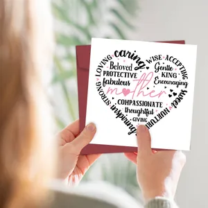 Close-up of Mother's Day card with heart word cloud and dark red envelope in hand