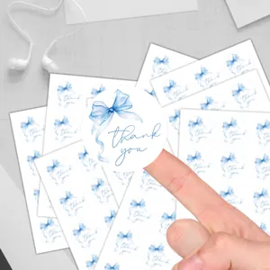 Detail of round Thank You stickers with blue watercolor bow for gift packaging
