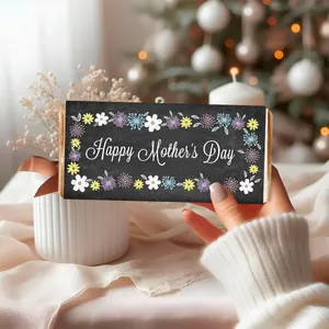 Macro detail of Happy Mother's Day candy wrapper with colorful floral patterns