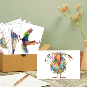 Artistic bird illustration greeting cards and kraft storage box on a wooden desk