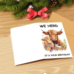 Detail showing watercolor highland cow card with craft envelope and festive background
