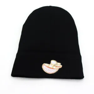 Black knit beanie featuring colorful mushroom embroidery for winter outdoor fashion