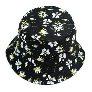 Reversible daisy floral bucket hat in black with yellow and white flower patterns