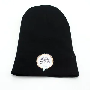 Black knitted beanie hat with pumpkin skull embroidery for winter outdoor warmth
