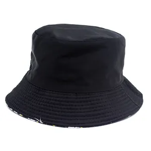Reversible black cotton bucket hat with daisy print lining and stitched brim details