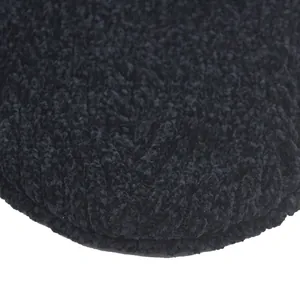 Close-up of thick black boucle knit material on a thermal winter beanie hat texture