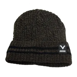 Close-up of thick ribbed knit texture and brown yarn detail on warm winter beanie
