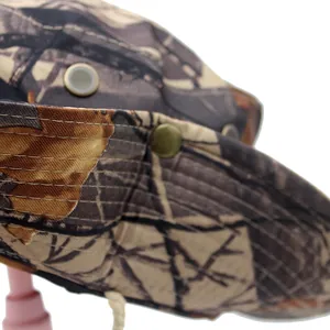Close-up of camouflage sun hat featuring metal ventilation eyelets and reinforced stitching