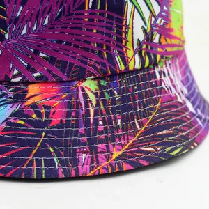 Unisex bucket hat with vibrant tropical leaf print in neon purple and orange colors