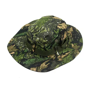 Macro detail of jungle camouflage boonie hat featuring metal eyelets and a wide sun brim