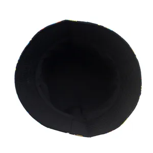 Double-sided foldable bucket hat with black interior and artistic dinosaur pattern print