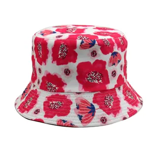 Detailed view of white bucket hat with vibrant red floral print and fine stitching