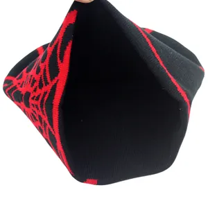 Knitted spider web beanie in black and red showing the warm double-layer fleece interior