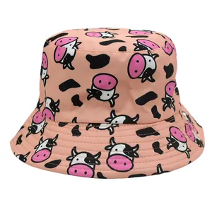 Reversible pink bucket hat with cute cartoon cow print and black spots for sun protection