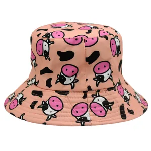 Detailed view of pink reversible bucket hat with cartoon cow print and reinforced brim