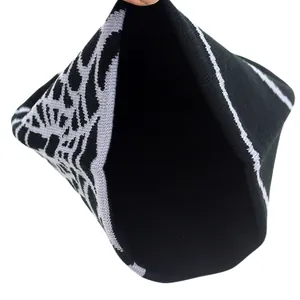 Detail view of double-layer knitted black beanie with grey tree jacquard pattern