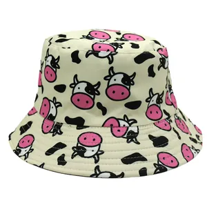 Close-up of reversible bucket hat with cute pink cow print and black spots on twill fabric