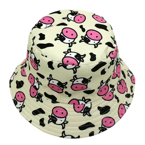 Detailed view of the cow print pattern on a reversible cotton bucket hat surface
