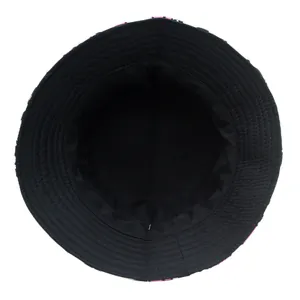 Detail view of double-sided bucket hat featuring reinforced stitching and cow print brim