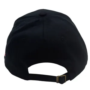 Detail view of the black baseball cap's adjustable fabric strap and antique bronze buckle