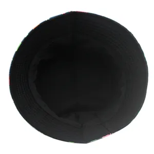 Reversible bucket hat with cartoon dinosaur print and solid black cotton lining interior