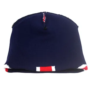 Detail of navy knit beanie showing red and white striped pattern on the folded cuff