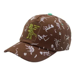 Brown cotton kids baseball cap with white dinosaur skeleton print and a t-rex patch