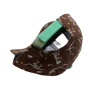 Detail view of the green velcro strap and dinosaur skeleton print on the cotton baseball cap