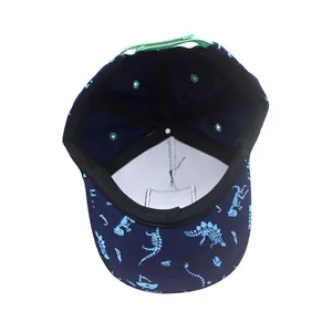 Internal view of dinosaur print baseball cap with green adjustable strap and sweatband