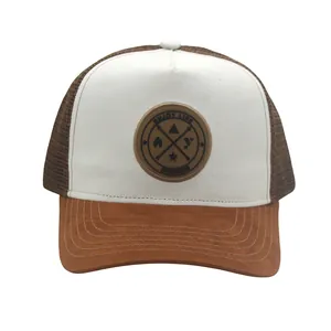 Detail of white suede front and brown mesh trucker hat with Enjoy Life circular patch