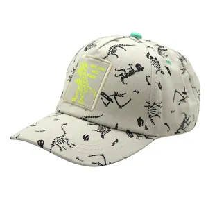 Detail of dinosaur bone print and neon patch on beige cotton kid's baseball cap