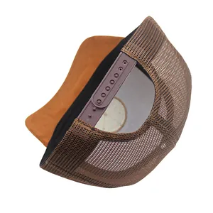 Detail view of adjustable snapback closure and breathable mesh on brown trucker hat