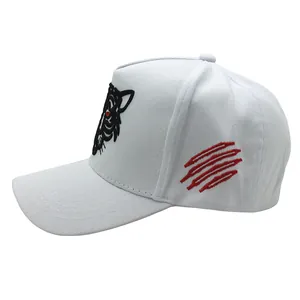 Close-up of white baseball cap with tiger head embroidery and red claw marks on side