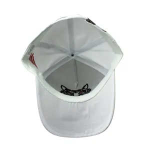 Detailed interior of a white cotton baseball cap showing the tiger head embroidery and lining
