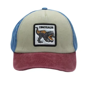 Detail of kids baseball cap featuring dinosaur patch embroidery and tricolor patchwork