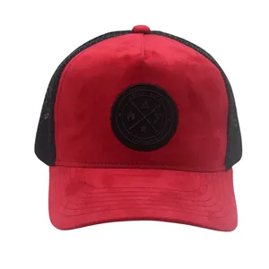 Detail of red suede front panel with black mesh and embroidered circular logo patch