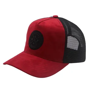 Close-up of red suede panel and black mesh texture on trucker hat with round patch