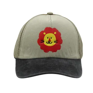 Detailed close-up of cartoon lion embroidery on washed cotton children baseball cap