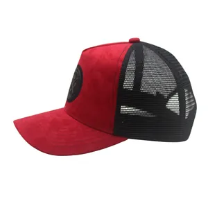 Detail of red faux suede baseball cap with black mesh back and side round badge logo