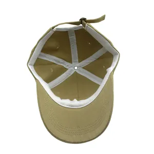 Détail de la boucle métallique réglable et couture intérieure sur la casquette kaki