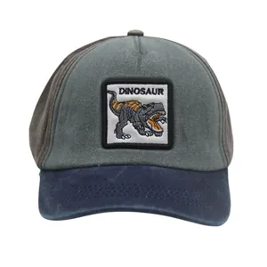 Close-up of dual-tone grey and navy kids dinosaur baseball cap with washed cotton texture