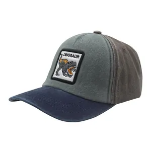 Detail of kids baseball cap featuring a dinosaur patch and multi-color panel design