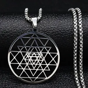 Macro detail of silver Sri Yantra sacred geometry pendant on a beaded steel chain