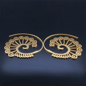 Bohemian gold hollow spiral earrings with geometric patterns in a symmetric view