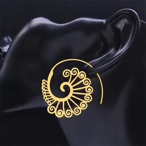 Bohemian gold hollow spiral earrings in stainless steel on black jewelry display