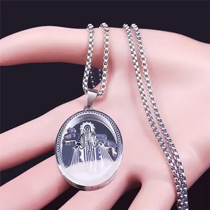 Macro shot of a silver oval religious medallion featuring Virgin Mary on a metal box chain